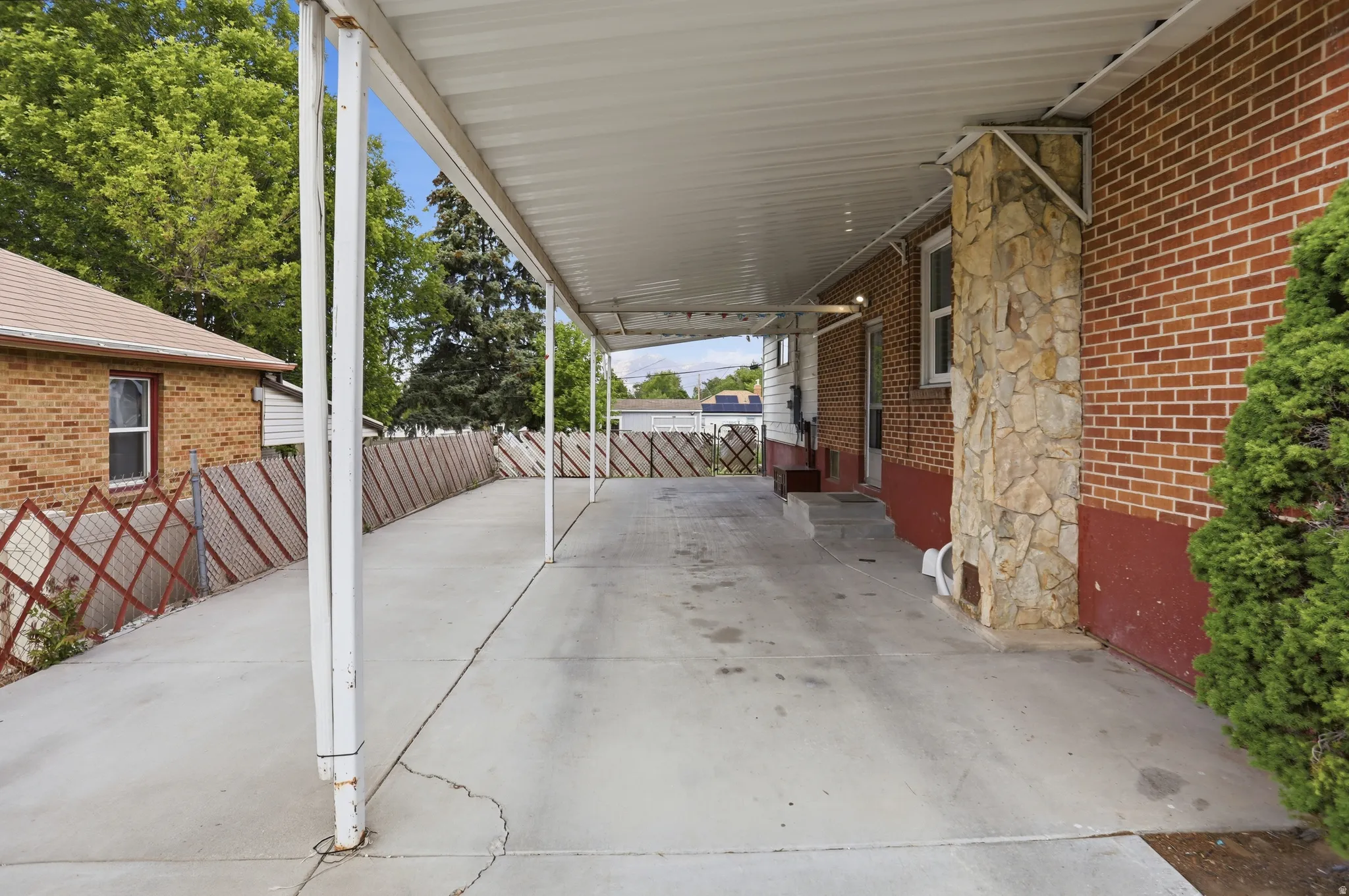 Covered concrete driveway with an extended carport structure