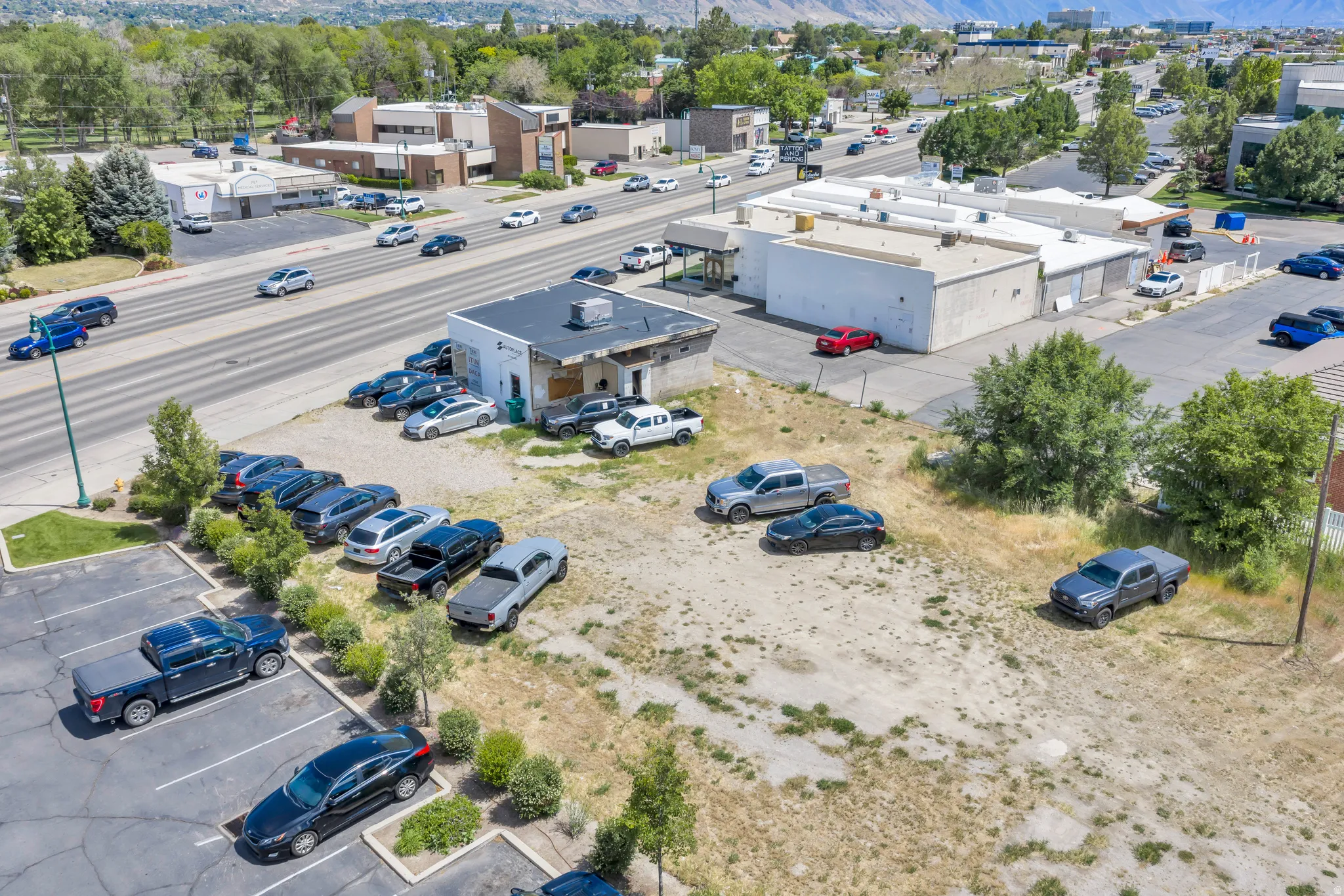 Commercial building featuring a flat roof and surrounding paved parking areas