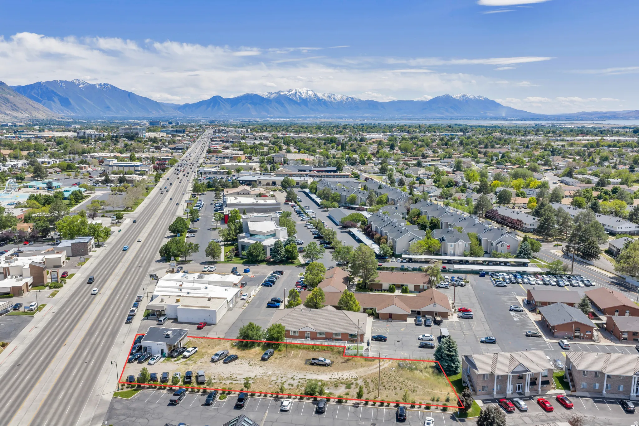 Aerial perspective showcasing a commercial property with mountain and lake features in the distance