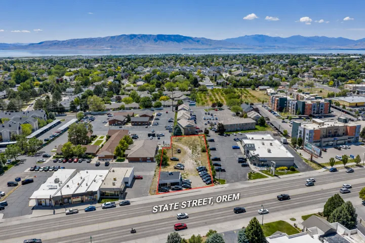 Aerial perspective highlighting a commercial property with significant frontage on State Street, Orem
