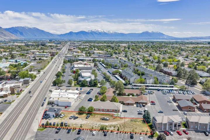 Aerial perspective showcasing a commercial property with mountain and lake features in the distance