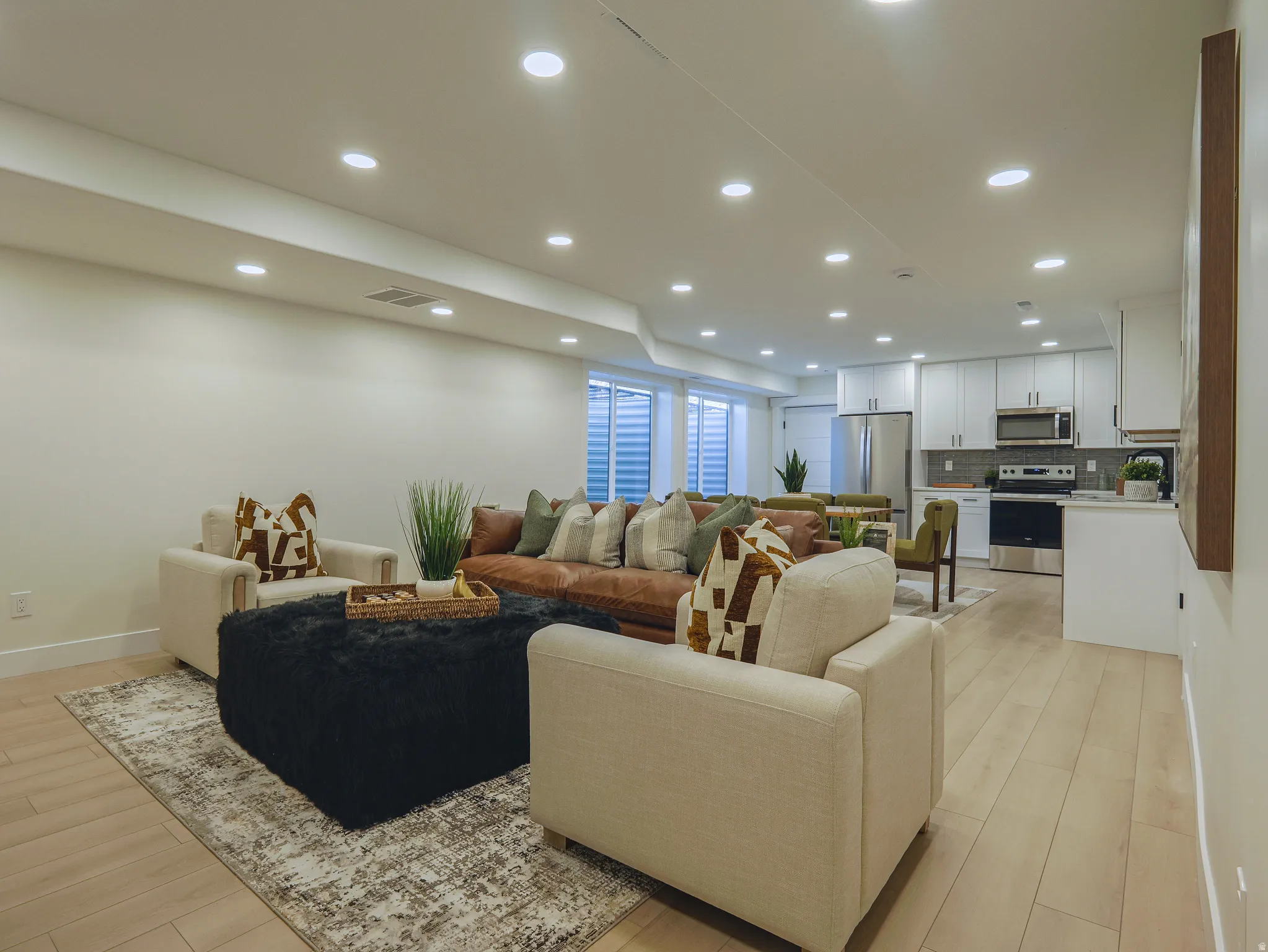 Open-concept living space featuring wood-finish flooring and recessed lighting
