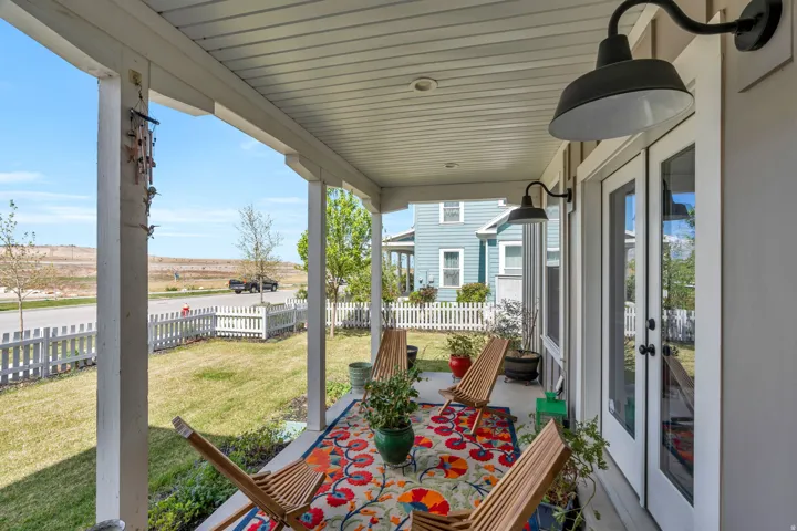 Fenced backyard featuring french doors