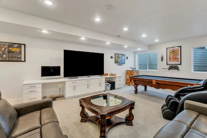 Living area with light colored carpet, pool table, recessed lighting, and a desk