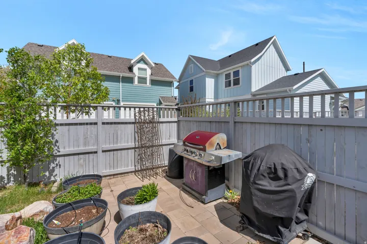 Fenced backyard with a grill