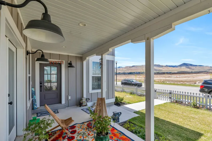 Covered porch featuring a mountain view