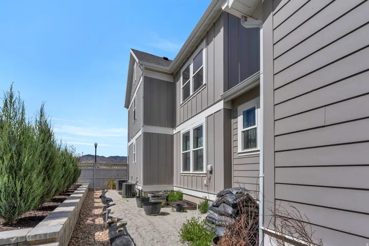 View of side of home with board and batten siding and a central air condition unit