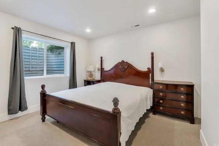 Bedroom featuring light colored carpet and recessed lighting
