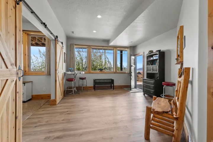 Street level, walk-in from driveway and garage attached. This is full daylight, but back of level is built-into the hillside, making it basement level.