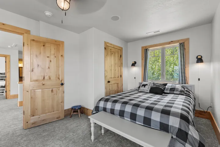 2 of 4 Bedrooms featuring light knotty pine doors and wood window trim