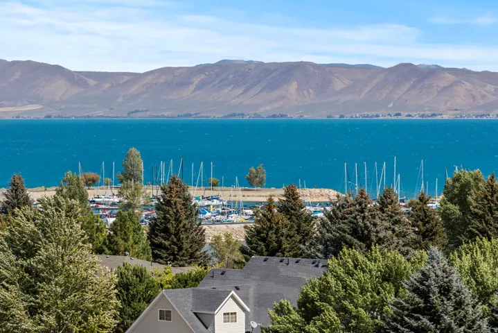 360 views from this home to view the marina, framed by rookie mountains and diverse evergreen and deciduous trees, framing the "Caribbean of the Rookies" Bear Lake.  We are on the deck, looking out right now in this photo!