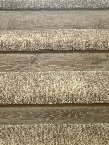 Let's go upstairs: MORE BEAUTIFUL DETAIL - Staircase featuring wood-finish risers and textured carpet treads