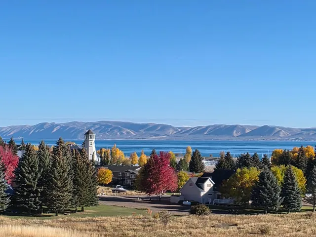 Fall photo of the marina and lakefront featuring the landmark lighthouse structure and varied residential architecture. Breathtaking!!!