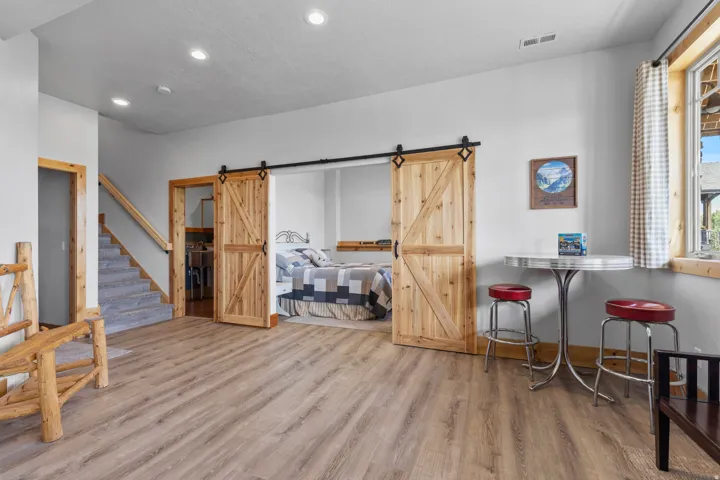 Lowest level family room with walk-in entrance from front of home's drive and attached garage.  Barndoors go into 4 of 4 bedrooms.