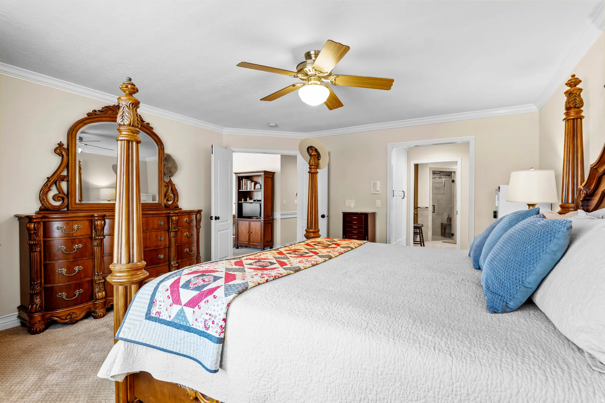 Spacious bedroom with light-colored walls and crown molding