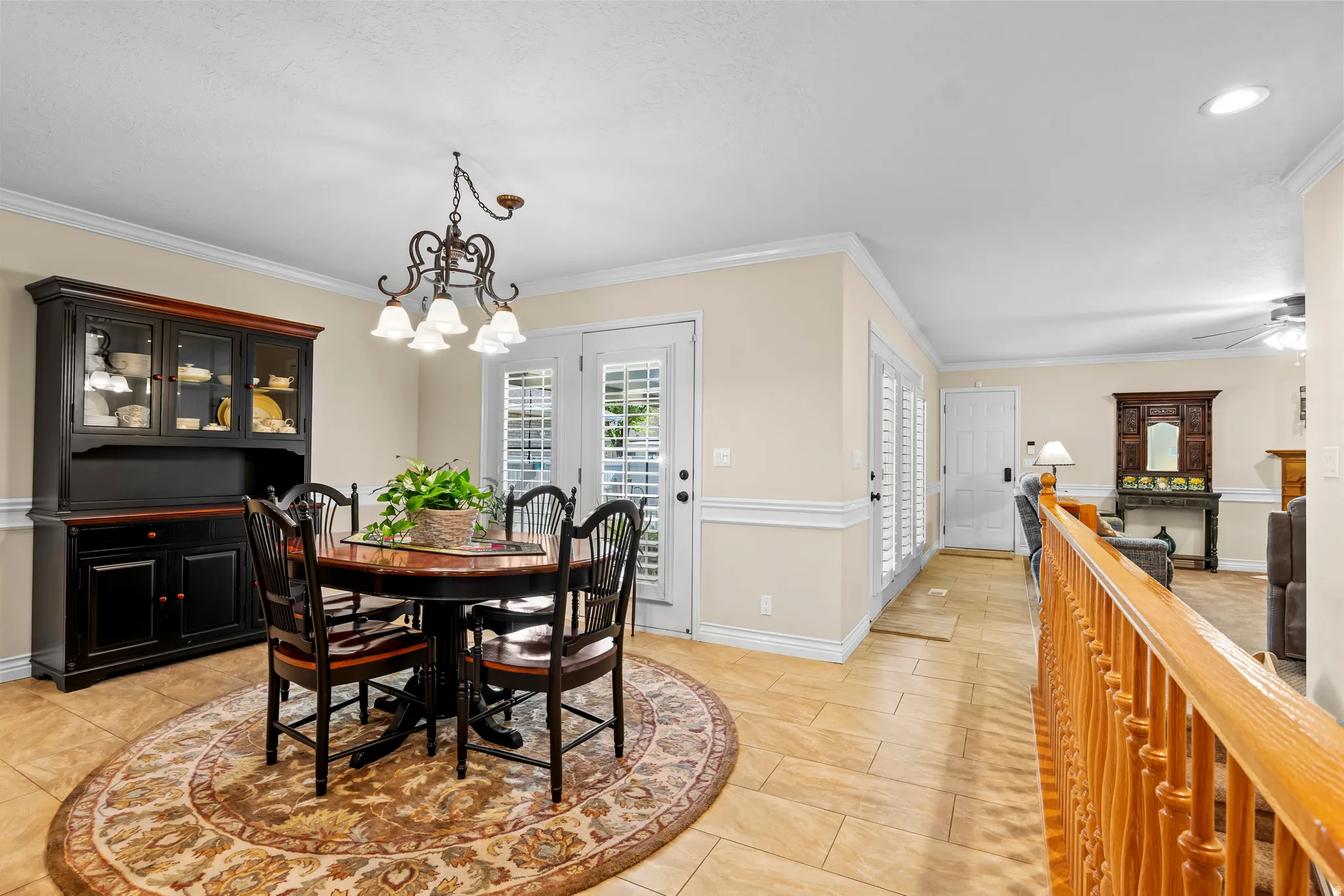 Dining area featuring ceramic tile flooring and crown molding