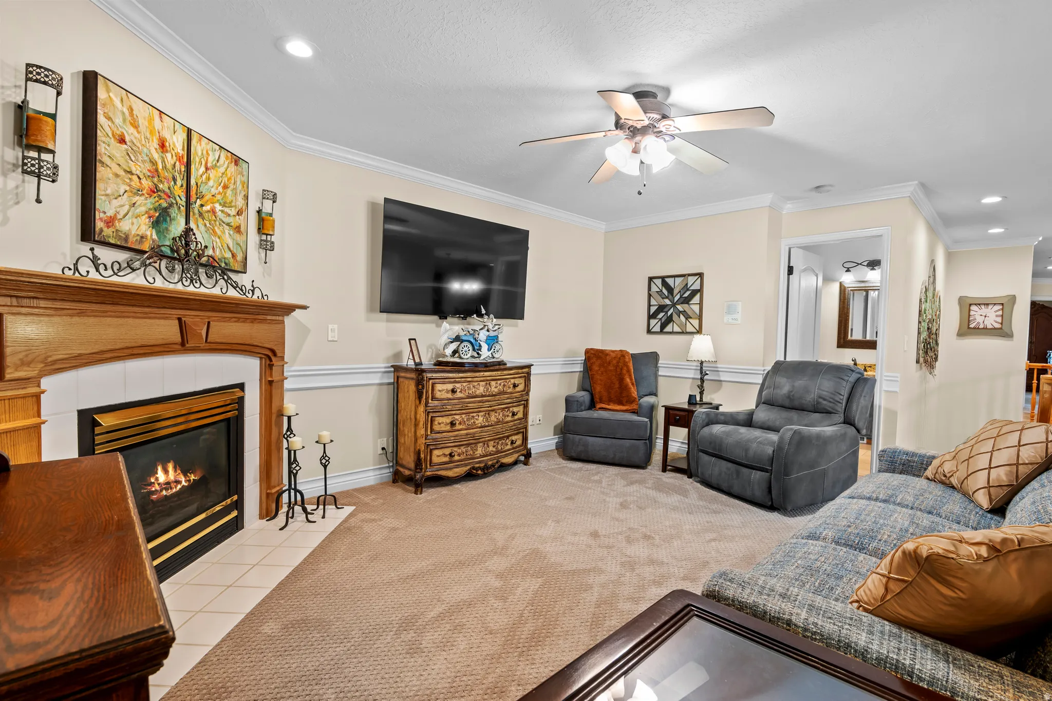 Living area featuring a gas fireplace with a wood mantle and tile hearth