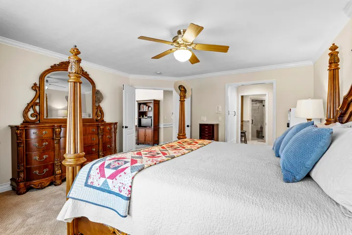 Spacious bedroom with light-colored walls and crown molding