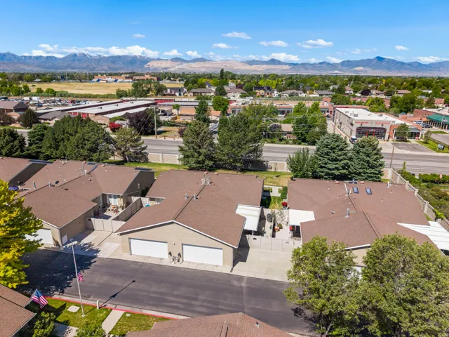 Aerial perspective showcasing a residential development with brown shingle roofs and integrated two-car garages