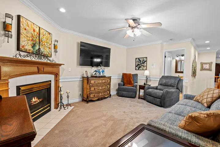 Living area featuring a gas fireplace with a wood mantle and tile hearth