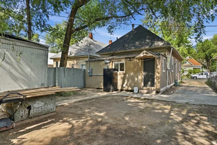 Rear exterior featuring a gabled roofline and multiple windows