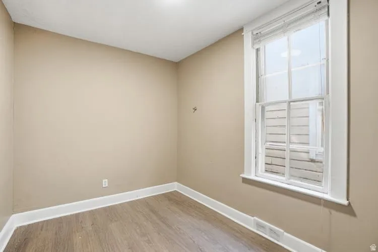 Neutral tone walls and wood-finish flooring define this interior space
