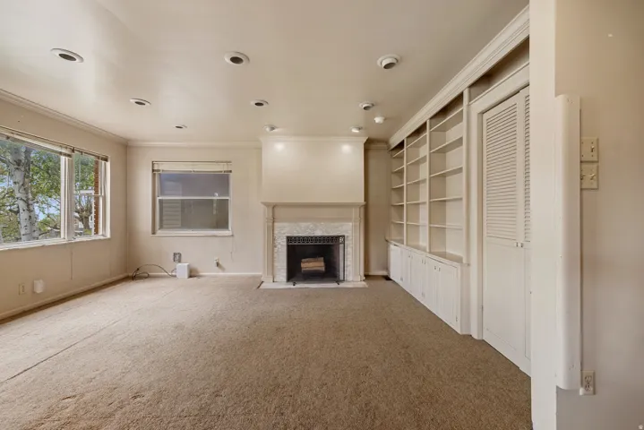Living area featuring a fireplace with a stone surround and a substantial mantle