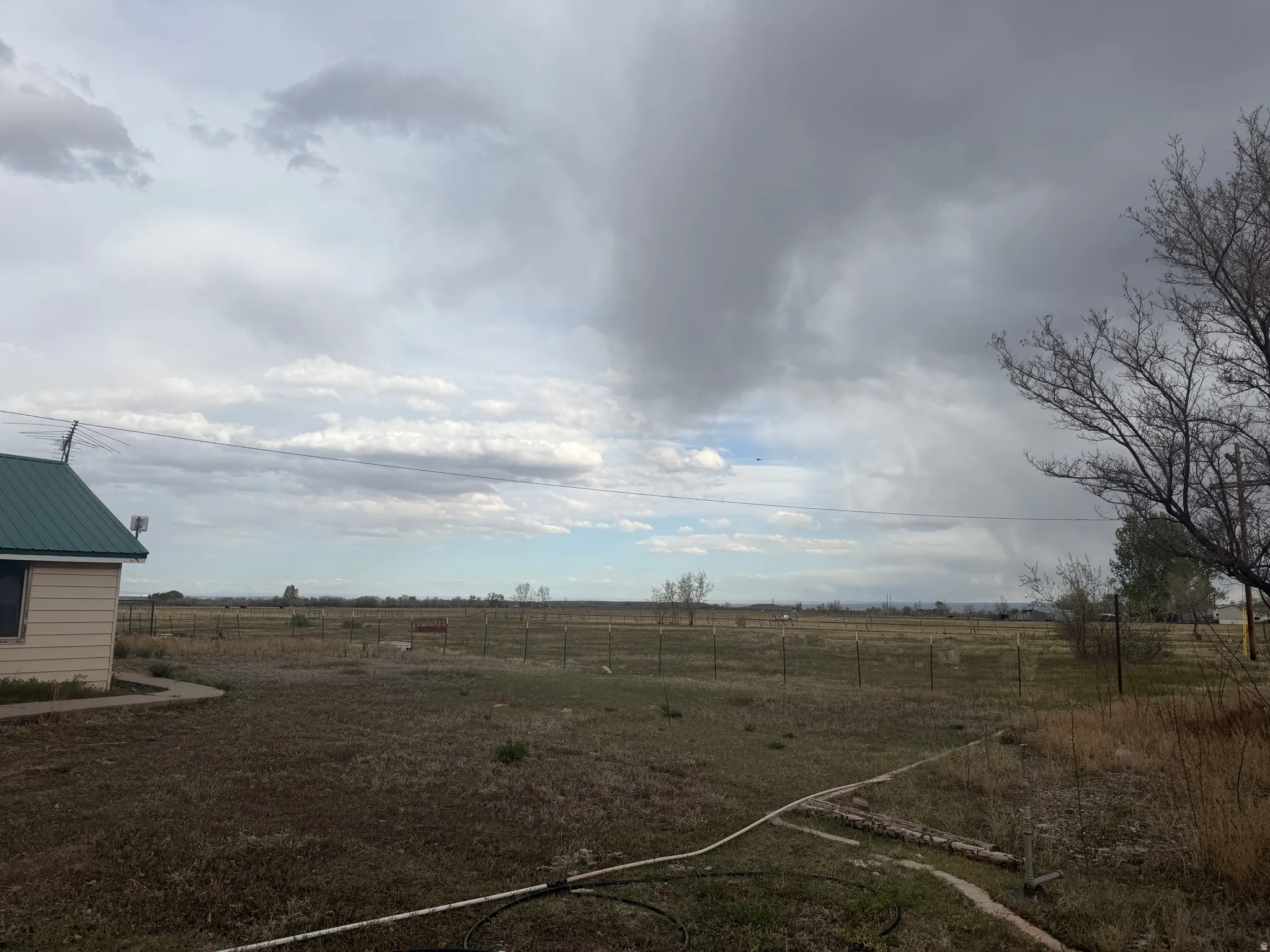Expansive rural landscape featuring a fenced perimeter