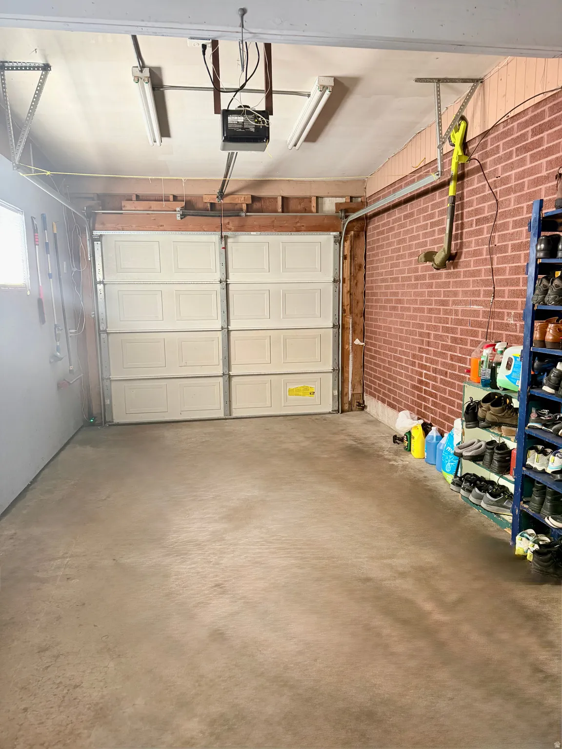 Attached garage with concrete flooring