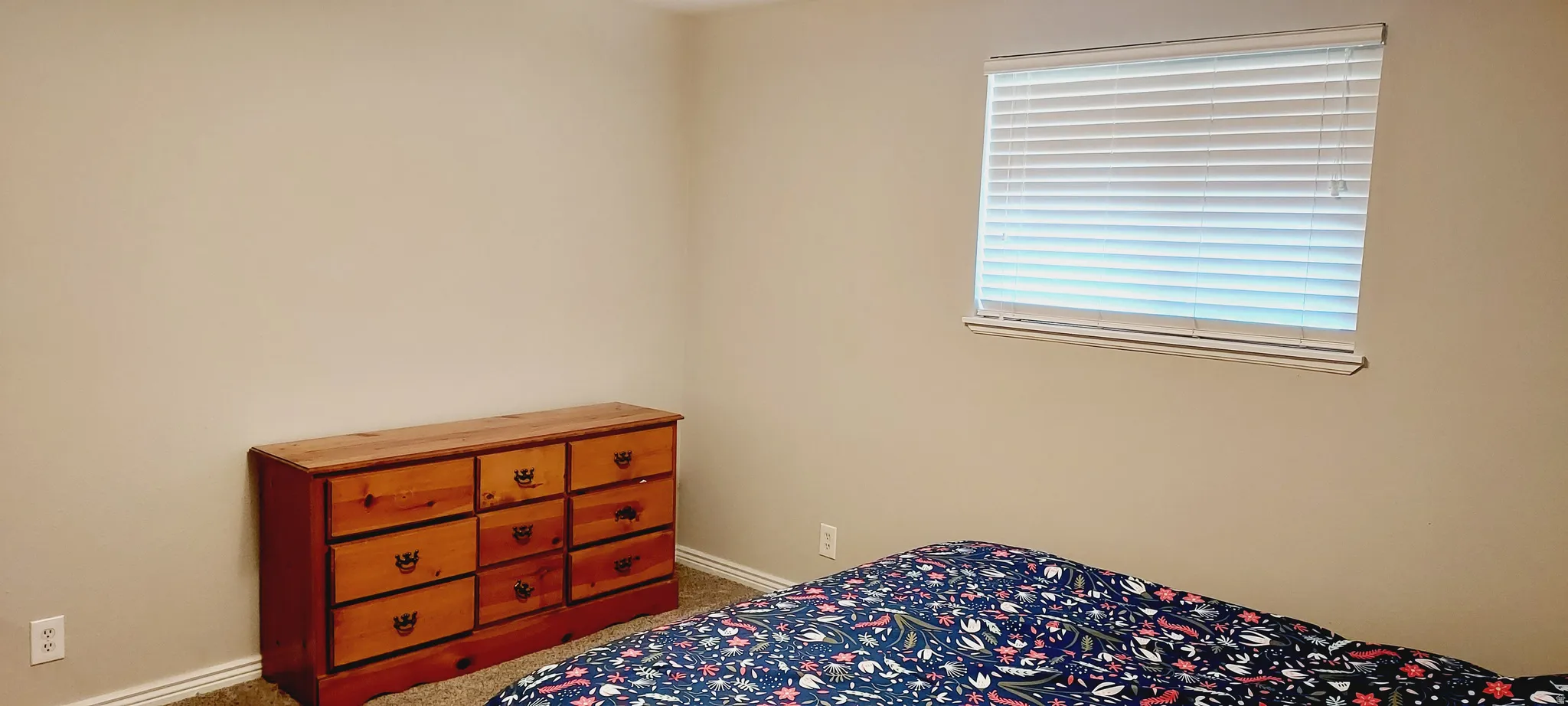 Bedroom featuring light colored carpet and baseboards