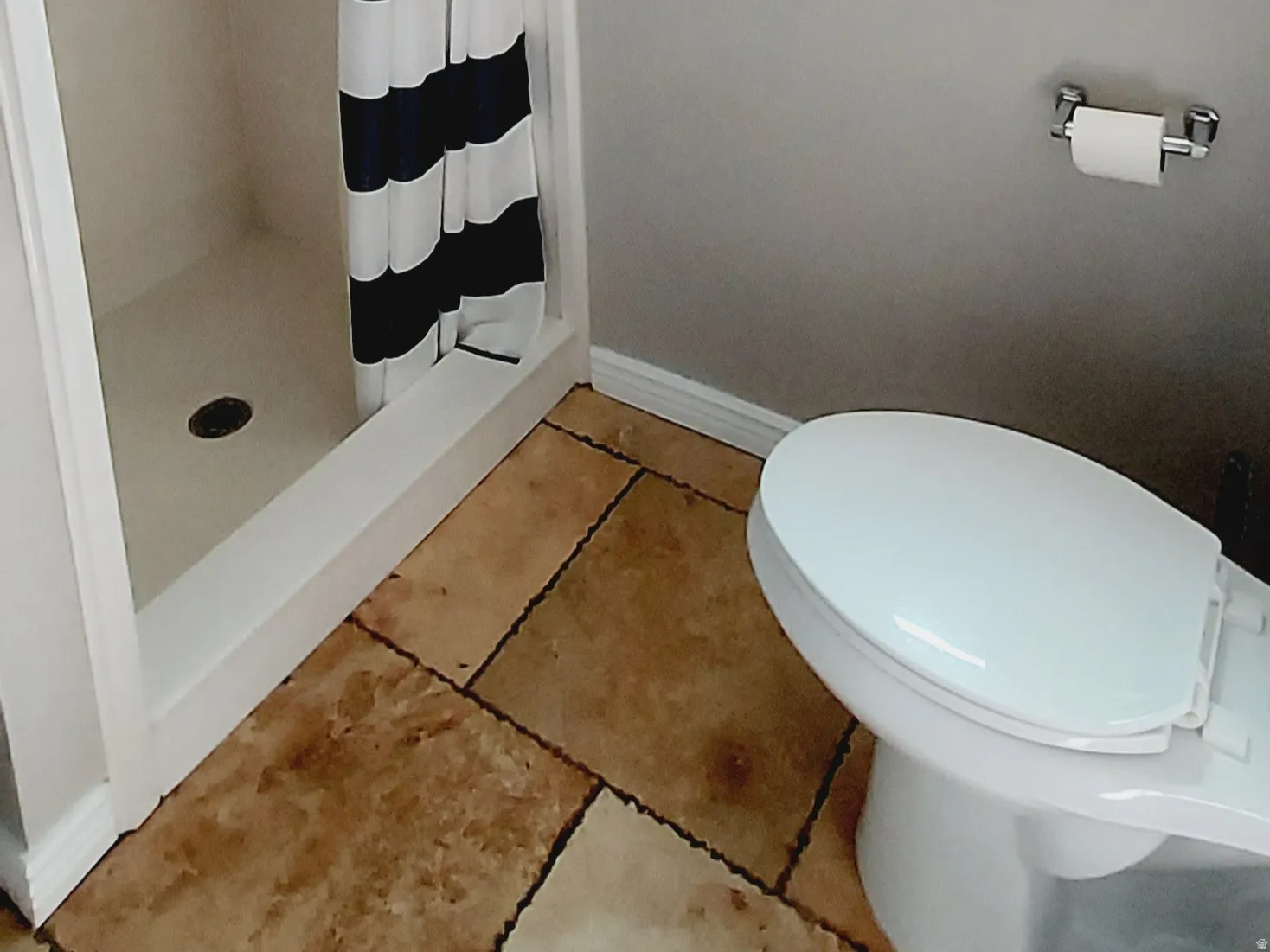 Bathroom featuring a shower stall, a textured ceiling, and tile patterned flooring