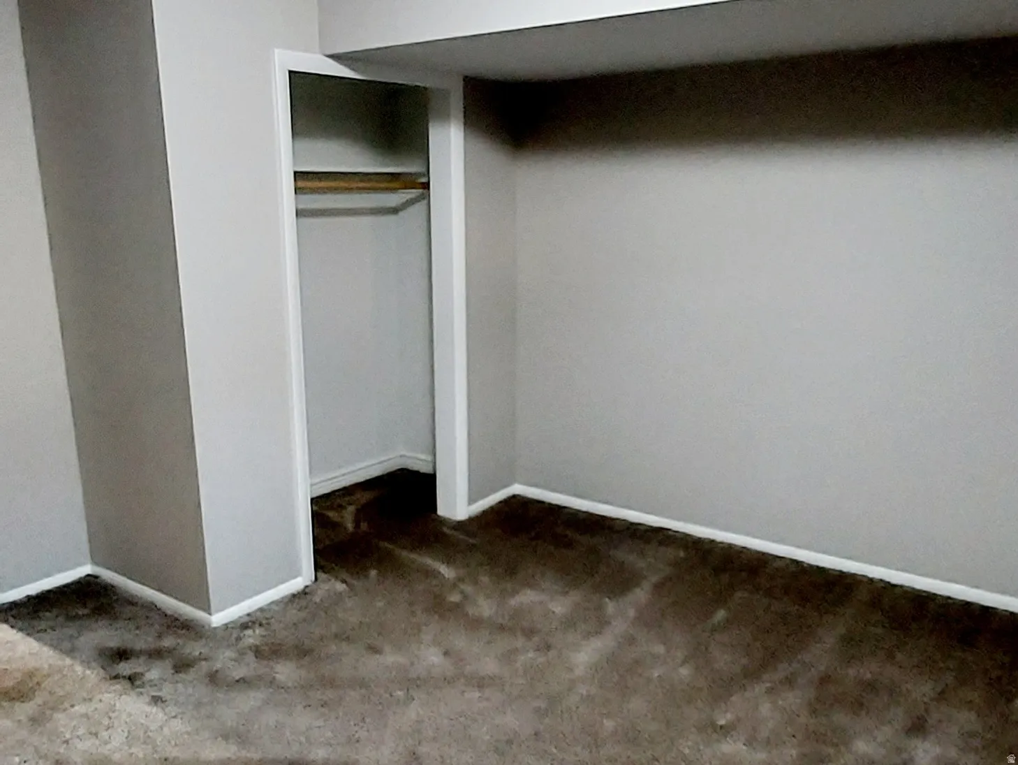 Unfurnished bedroom with carpet, a textured ceiling, and a closet