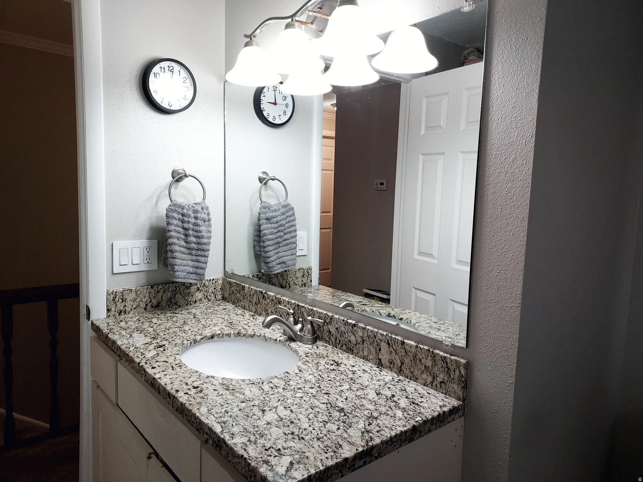 Bathroom featuring vanity and a textured wall
