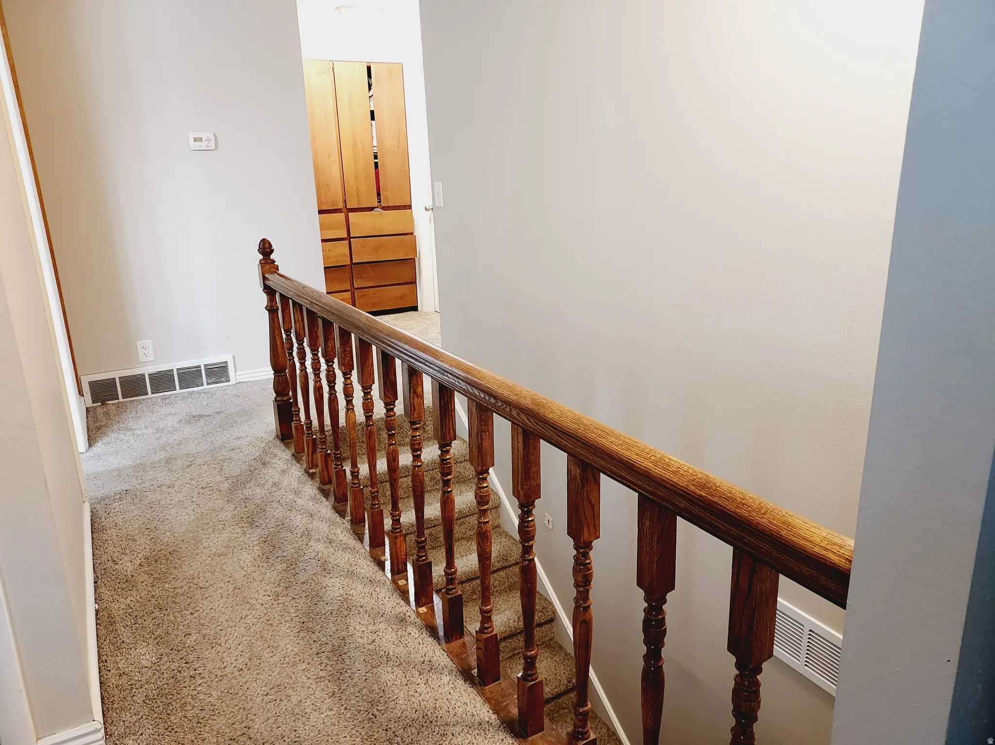 Stairway featuring carpet floors and baseboards