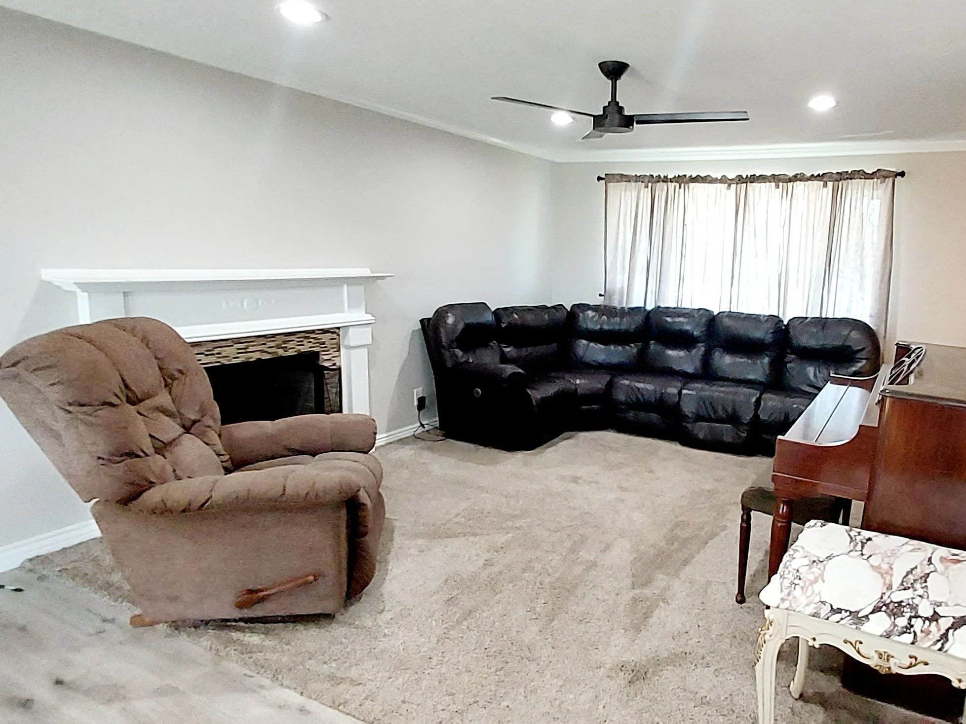Carpeted living room with a fireplace, ornamental molding, a ceiling fan, and recessed lighting