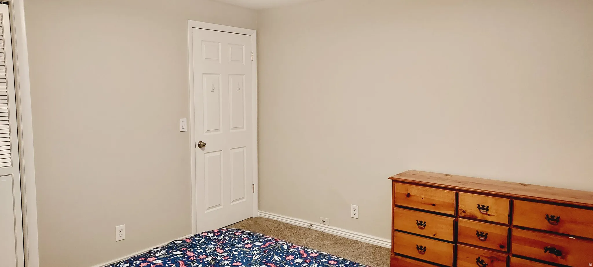Bedroom featuring baseboards and light colored carpet