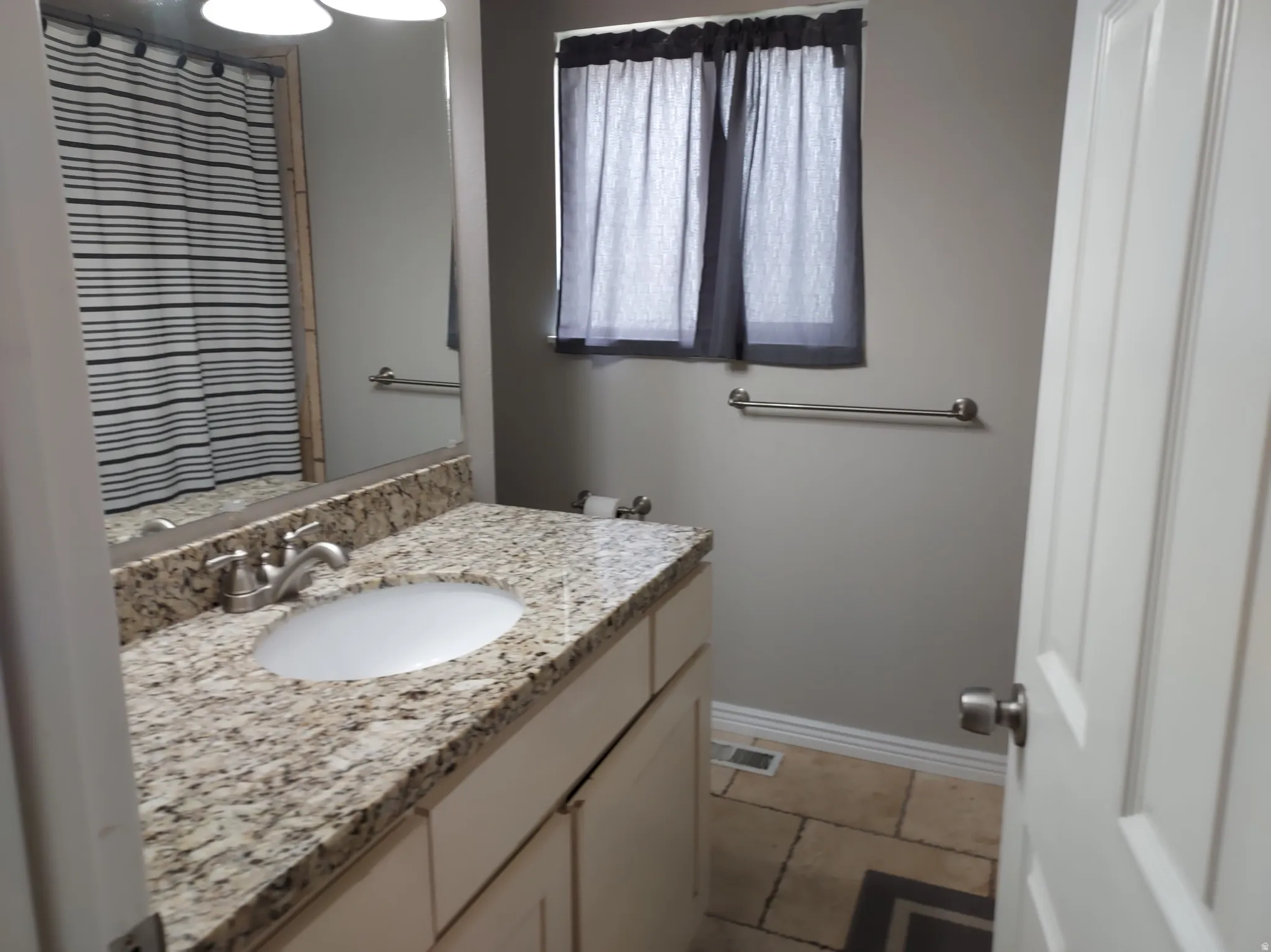 Bathroom with vanity and baseboards