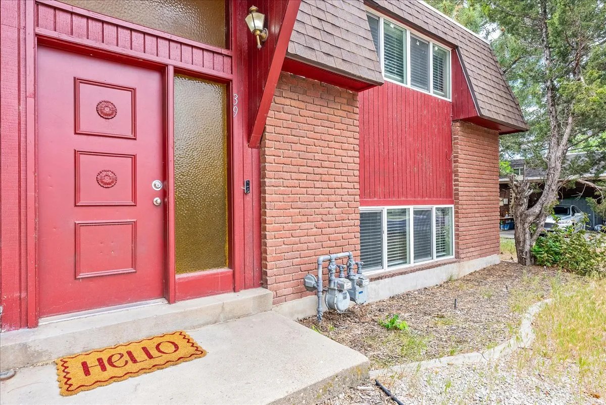 Red brick exterior with vertical red siding accents