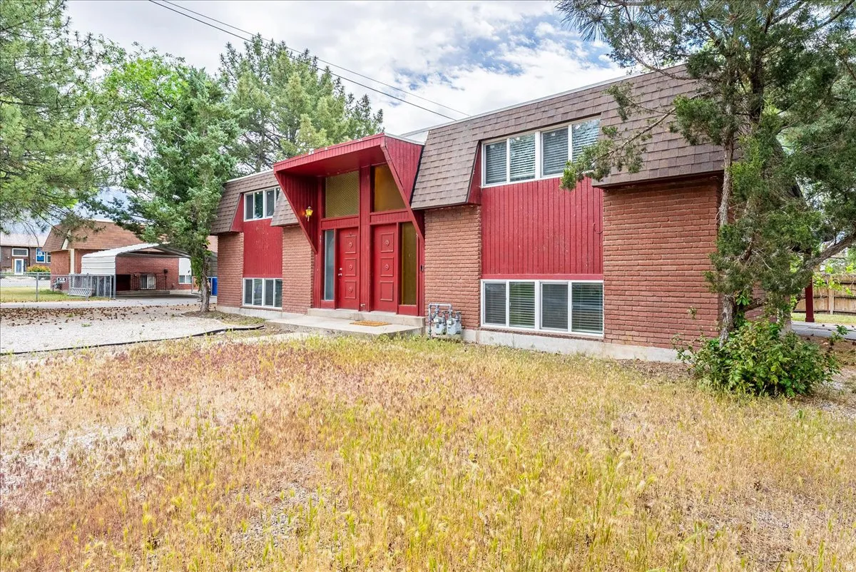 Two-story architectural design featuring brick and vertical siding