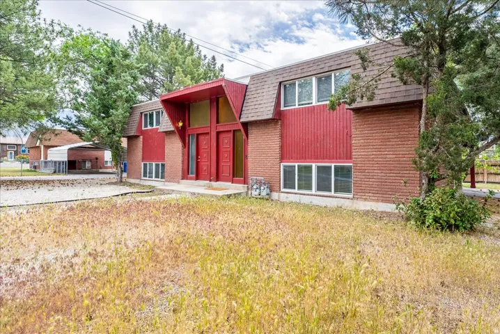 Two-story architectural design featuring brick and vertical siding