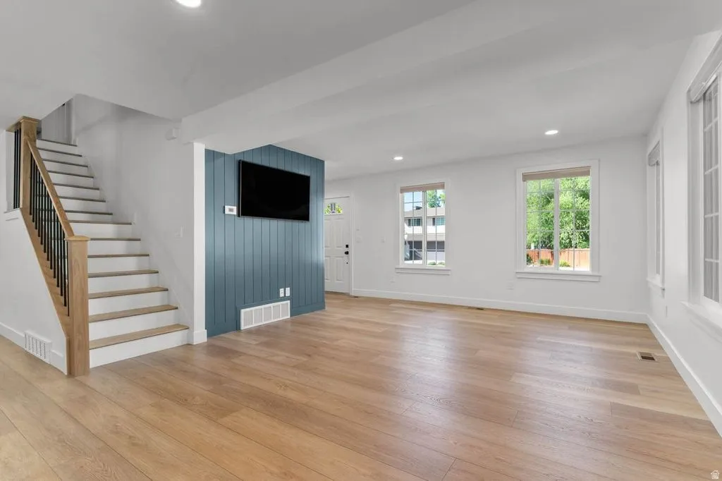 Living area featuring wood-finish flooring and multiple windows