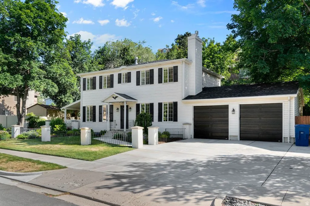 Traditional-style exterior with white siding, black shutters, and a covered front entry