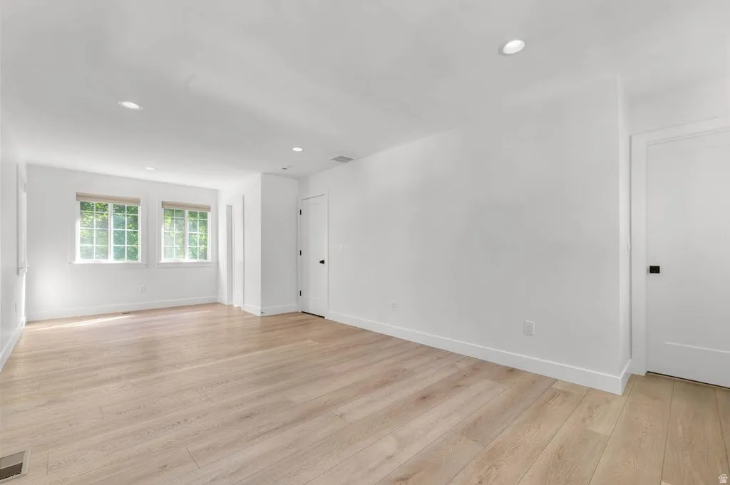 Bright interior space featuring light wood-finish flooring, recessed lighting, and white walls