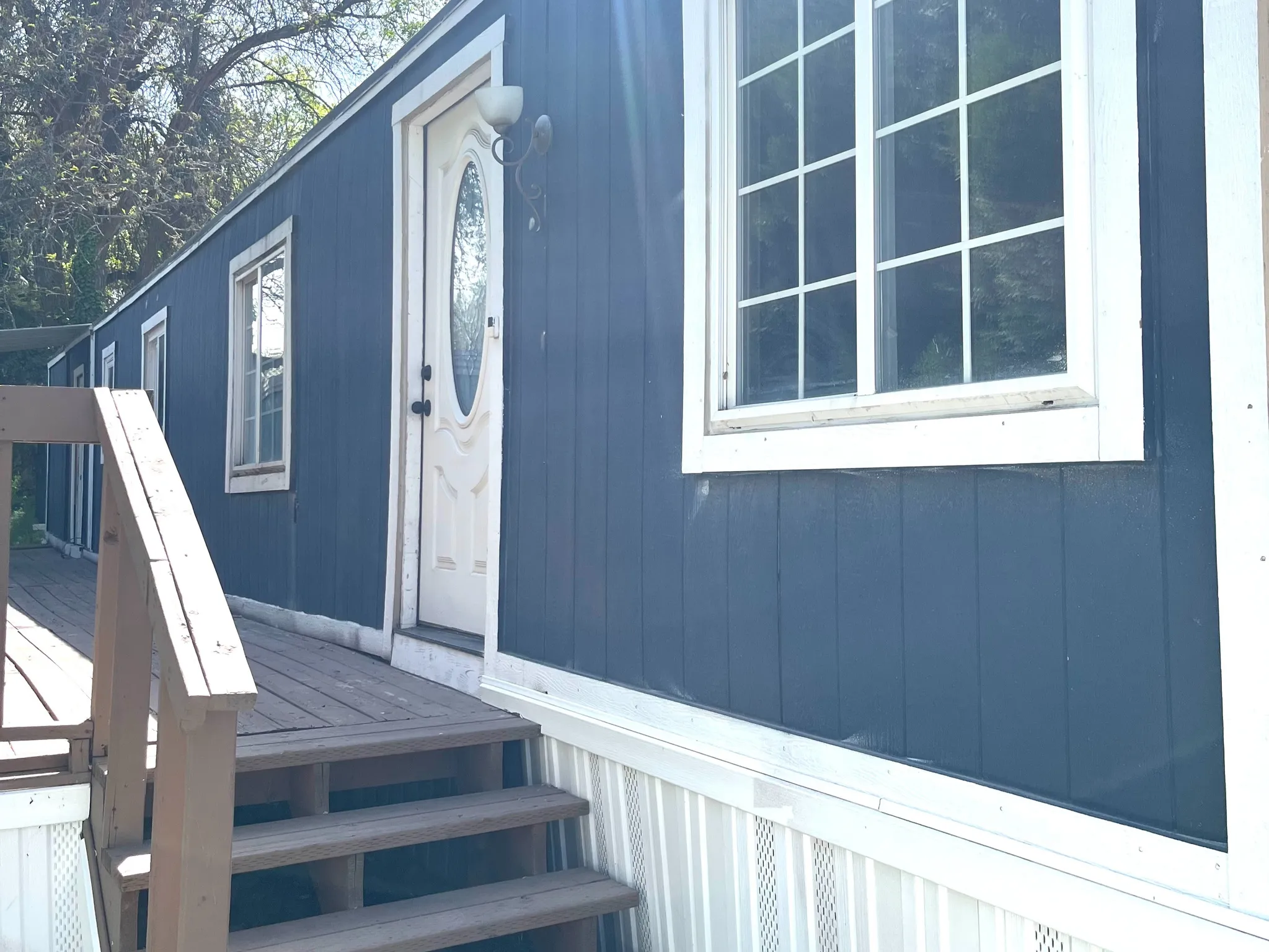 Dark blue vertical siding with white trim