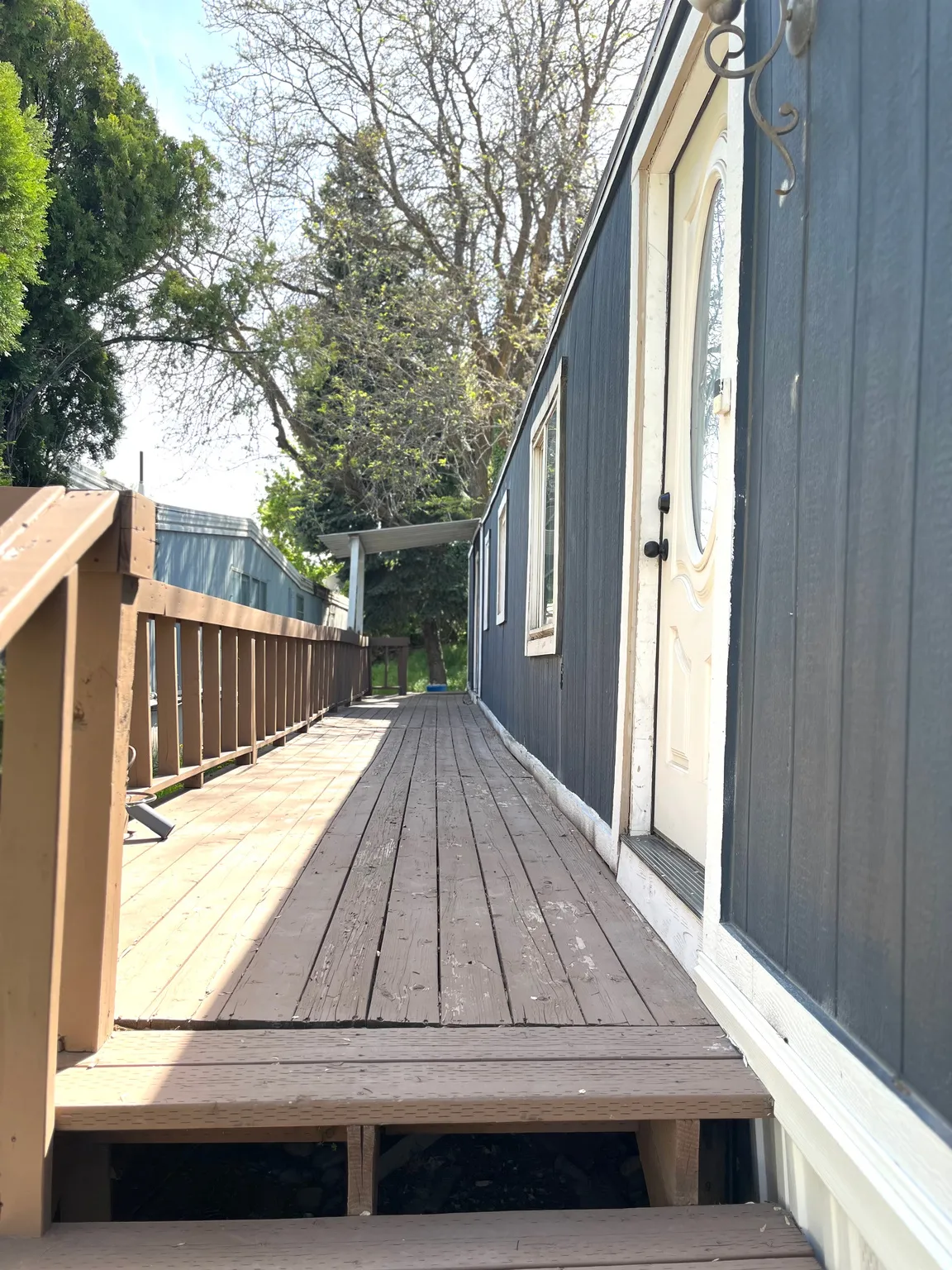 Long wooden deck with a wooden railing