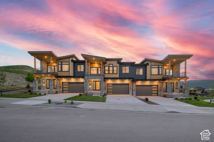 Modern townhome architecture featuring stone and wood-look siding