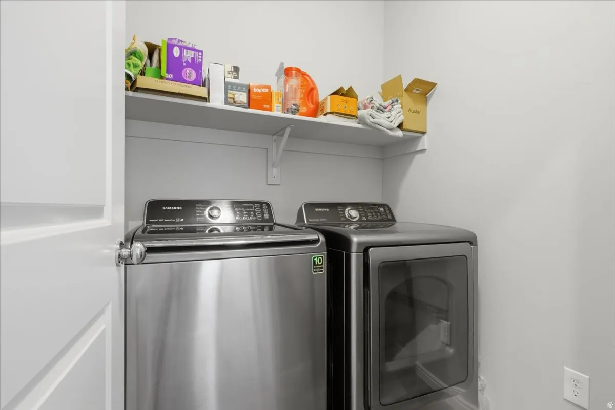 Dedicated laundry area featuring a white wall shelf, offering additional storage
