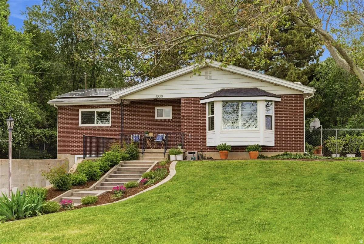 Brick exterior with a prominent bay window and white trim