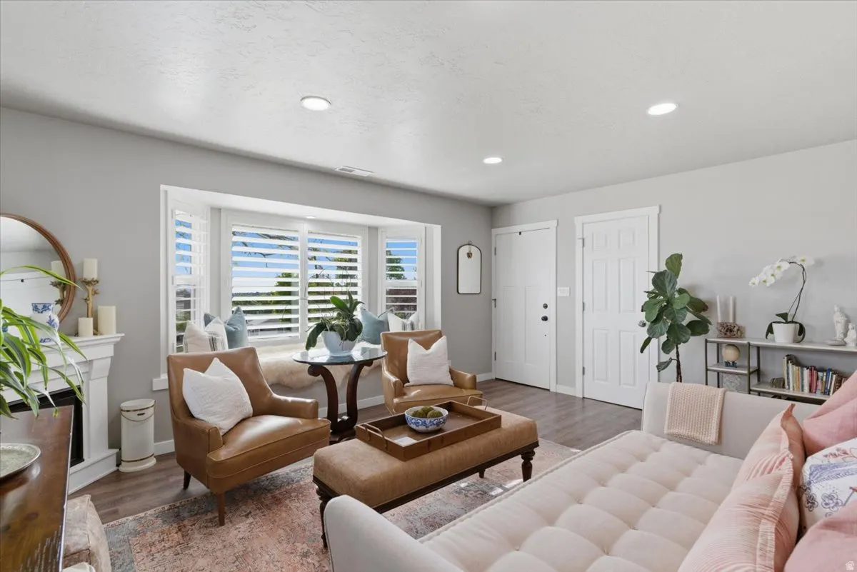 Living area featuring a bay window with plantation shutters and a built-in window seat