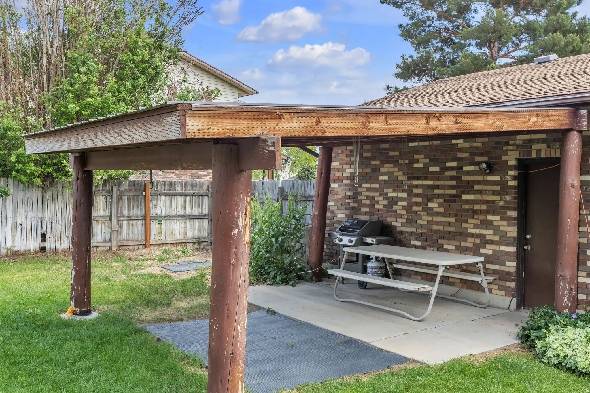 Wood-framed patio cover offering shaded outdoor space